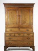 A GEORGE III WELSH OAK HOUSEKEEPER'S CUPBOARD C.1760-80 the fluted frieze above a pair of fielded