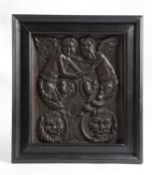 A FRENCH CARVED OAK PANEL C.1580-1600 depicting two angels above a pair of lion's masks, in a