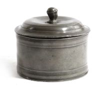 A GEORGE III PEWTER TOBACCO BOX C.1790 of circular form, the push-on domed lid with a male head
