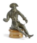 A FRENCH BRONZE FIGURE OF A MAN EARLY 18TH CENTURY cast seated with his right hand clasped, on a