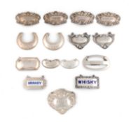 A collection of silver wine labels, comprising: a matched set of four by William Adams Ltd,