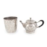 A small 19th century continental silver teapot, marks worn, circular form, embossed foliate