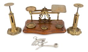 An early-20th century brass letter scales, unmarked, wirework scale frame, five weights, on a shaped