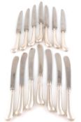 A set of seven modern silver pistol grip table and dessert knives, the dessert knives by Richard