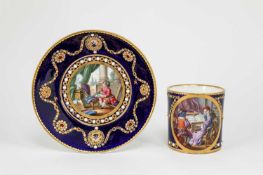 A SEVRES STYLE CABINET CUP AND SAUCER DATE CODE 'dd' the cup with an oval scene of children