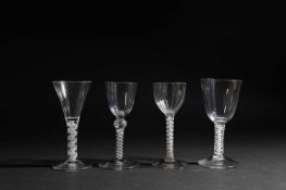 FOUR LARGE WINE GLASSES 18TH CENTURY AND LATER comprising: one with a rounded funnel bowl, one