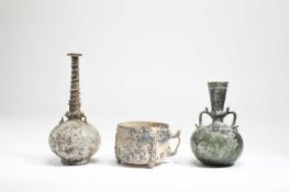 AN ISLAMIC GLASS BOTTLE 11TH / 12TH CENTURY AD the freeblown vessel with a globular body on a