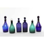 FOUR BLUE GLASS SPIRIT DECANTERS AND STOPPERS LATE 18TH AND 19TH CENTURY comprising: two of mallet