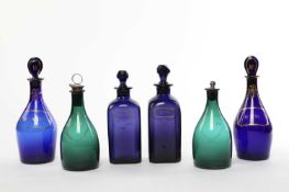 FOUR BLUE GLASS SPIRIT DECANTERS AND STOPPERS LATE 18TH AND 19TH CENTURY comprising: two of mallet