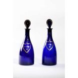 A PAIR OF BLUE GLASS DECANTERS AND STOPPERS C.1800 each of mallet form with a tear-shaped stopper,