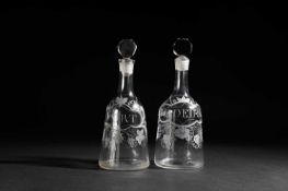 TWO ENGRAVED GLASS DECANTERS AND STOPPERS C.1765 each of sugarloaf form with a faceted stopper,