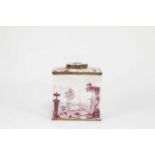 A SOUTH STAFFORDSHIRE ENAMEL TEA CANISTER AND COVER C.1770 of rectangular form, puce painted with