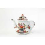 A MEISSEN TEAPOT AND COVER C.1730 moulded with a mask to the base of the spout, the body and cover