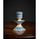 A RARE DELFTWARE SMALL CANDLESTICK LAMBETH, C.1650-80 the urn shaped socket above a dished drip