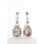 A PAIR OF CONTINENTAL MILCHGLASS DECANTERS AND STOPPERS 19TH CENTURY painted with oval portraits