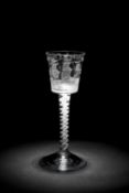 A RARE 'PRIVATEER' OPAQUE TWIST WINE GLASS C.1757 the bucket bowl engraved with a ship in full
