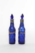 A PAIR OF GEORGIAN SILVER MOUNTED BLUE GLASS SAUCE BOTTLES AND STOPPERS UNMARKED, LATE 18TH /