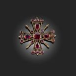 A GARNET CRUCIFORM BROOCH