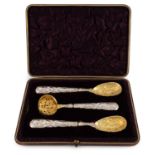 A cased pair of Victorian silver strawberry servers and sugar sifter,