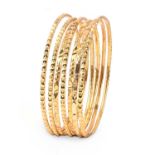 A COLLECTION OF SEVEN YELLOW GOLD BANGLES