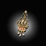AN ARTS AND CRAFTS GOLD AND ENAMEL PENDANT MODELLED AS A STYLISED GALLEON