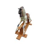 A traditional rocking horse by Haddon, Wallingford raised on a stripped pine stretcher base124 cm