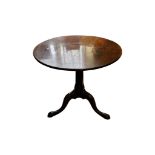 A Georgian mahogany tripod table with birdcage action, raised on a turned column and tripod