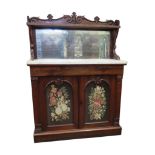 A Regency rosewood chiffonier enclosed by a pair of panel doors with tapestry panel, set beneath a