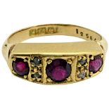 A Victorian three-stone ruby ring, interspersed with four rose-cut diamonds, in 18ct gold, size F