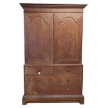 A 19th century limed oak linen press the upper section enclosed by a pair of arched panelled doors