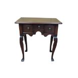 A small Georgian oak lowboy with three drawers over a shaped arch, raised on four raised supports.
