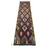 A Maimana Kilim runner with bright geometric detail. 294cm x 79cm.