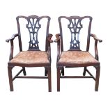A pair of reproduction Chippendale style carver chairs with pierced and carved slats over drop in