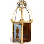 A decorative hexagonal porch lantern set with amber stained and painted glass panels decorated