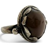 A scarce 17th century silver-mounted amuletic toadstone ring, set with a smooth, domed brown