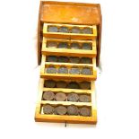 Vintage wooden mid century desk storage with a selection of vintage pennies