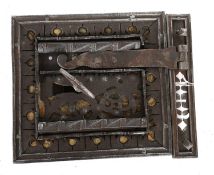 A 17th Century Iron Chest Lock, with twin bolt through decorated strap staples, the staple has two