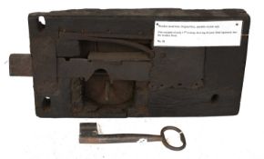 A 17th Century Oak-Cased Lock, with original key, operable from one side only 40cm by 20.5cm