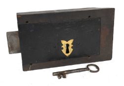 An Oak-Cased Plate Lock, brass bridge ward, one iron tumbler, shaped case at end, with key 35cm by