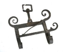 An 18th Century English Wrought Iron Kettle Tilt, the pivoting hook with a scrolled frame and sprung