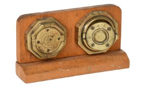 Two 19th Century Brass Octagonal Shaped Escutcheons, with circular pivoting doors, mounted on a