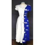 A vintage Tina Leser dress, cream corded fabric with blue panel embroidered with fish, likely