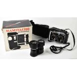 A Mamiya C220 TLR camera with 105mm with Mamiya-Sekor lens, an extra set of lenses, instructions and