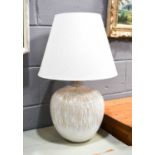 A modern white Studio pottery style ovoid lamp base with cream linen shade, lamp base 41cm high.
