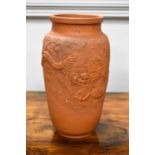 A Japanese Tokoname terracotta vase decorated with a dragon amongst clouds, 26cm high.