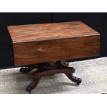A Regency mahogany drop leaf pembroke table, the centre column with quatreform base and scroll feet,
