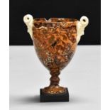 A late 18th century Wedgwood and Bentley variegated agate style urn with Bacchus handles creating