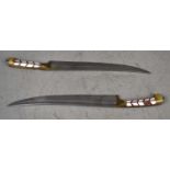 A pair of 19th century Indo-Persian daggers, curved blade measuring 22cm, mother of pearl handle.