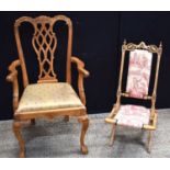 A vintage Chippendale style carved mahogany armchair with a pierced interlaced ribbon splat back,