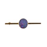 A 9ct gold and opal tie pin / brooch, the circular opal doublet set on a bar, with steel pin, 4.6g.